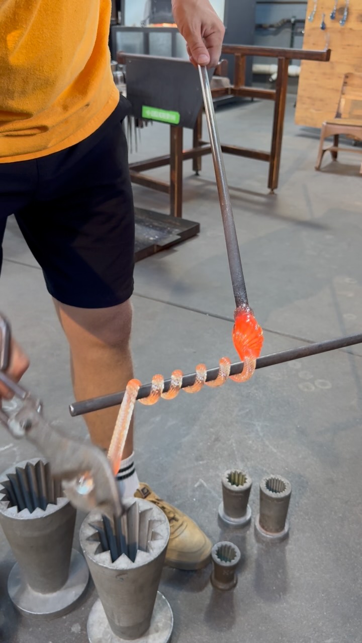 Instagram post with the caption: 'Molten glass + a steady hand = the perfect pumpkin stem curl...'